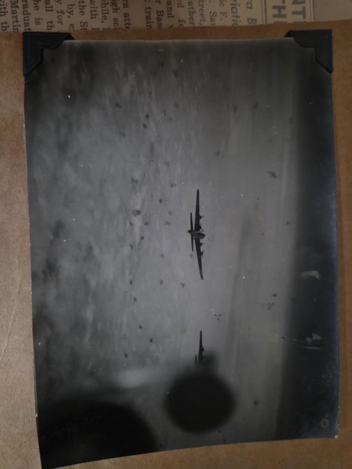 Scrapbook print of two B-17s in flak, photo corners on brown album paper, a shadow on the print, marked Brunswick in the family’s hand
