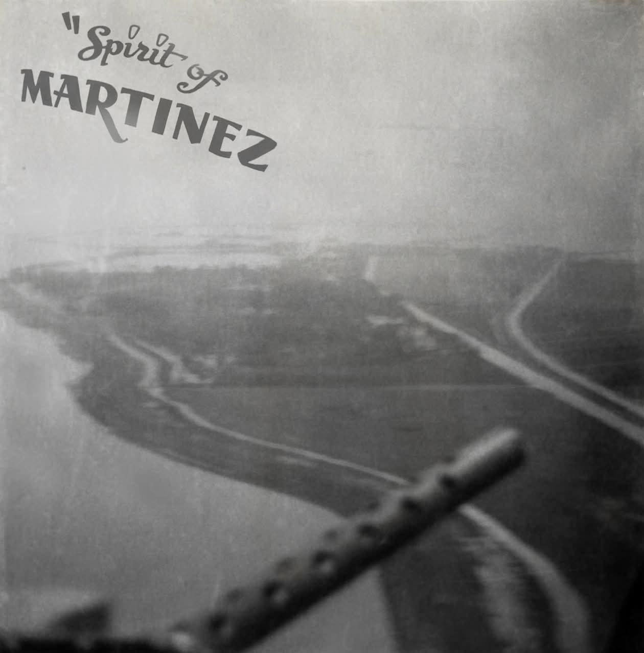 Aerial view of a river bend and fields from a B-17, a machine gun barrel in the foreground, Spirit of Martinez lettered on the print later