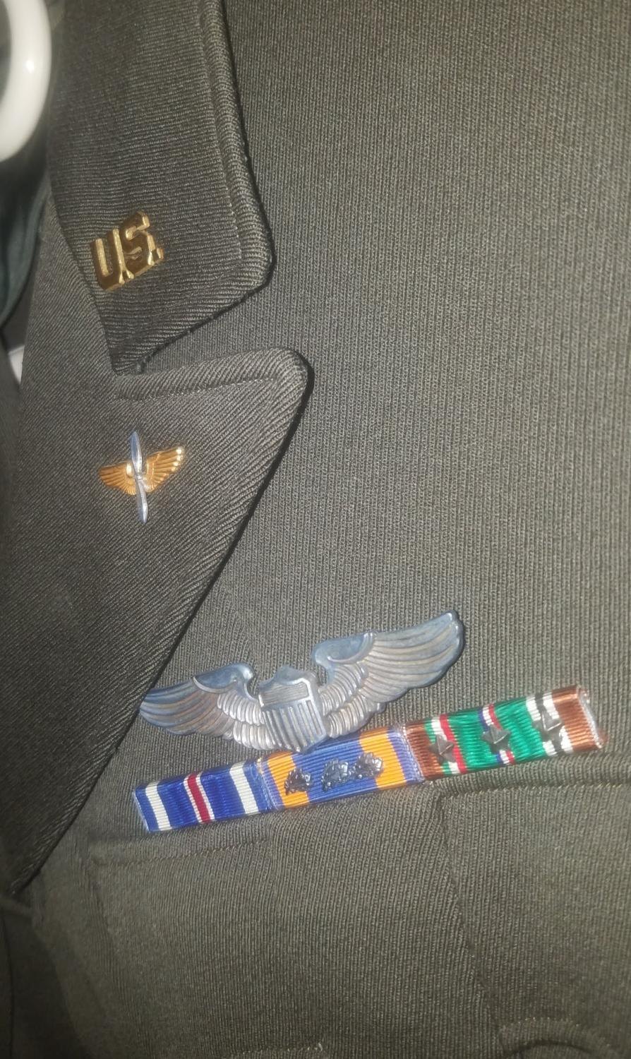 Olive service coat: US collar insignia, Air Corps propeller, silver pilot wings, ribbon bar with Distinguished Flying Cross, Air Medal with three clusters, and EAME campaign medal