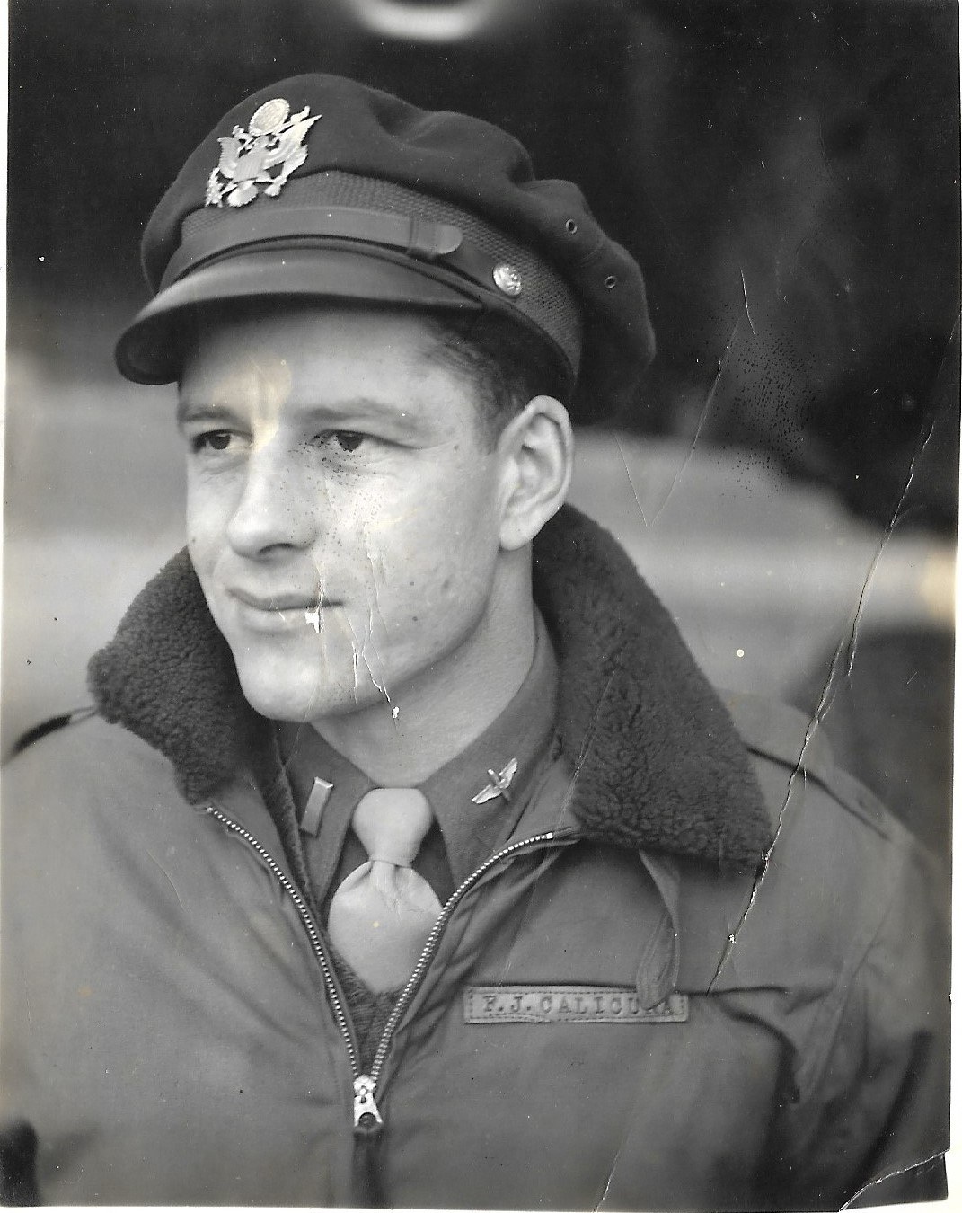 Frank J. Calicura in a crusher cap and B-15 jacket, name tape F.J. CALICURA, pilot wings on the shirt