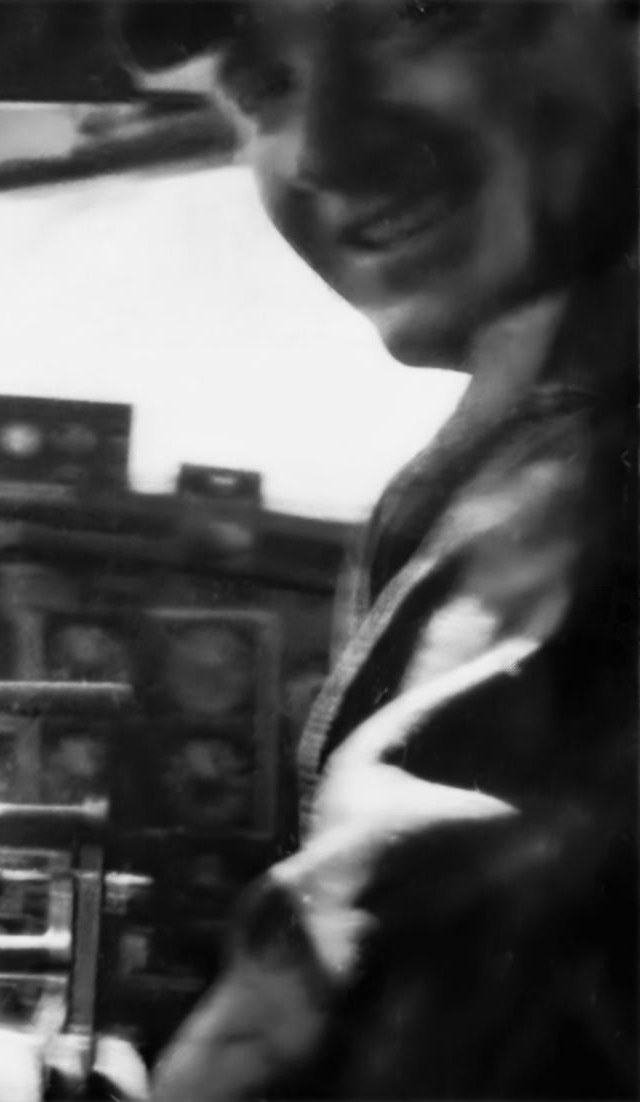 Copilot Victor G. Probst in the right-hand seat of a B-17, looking back toward the camera