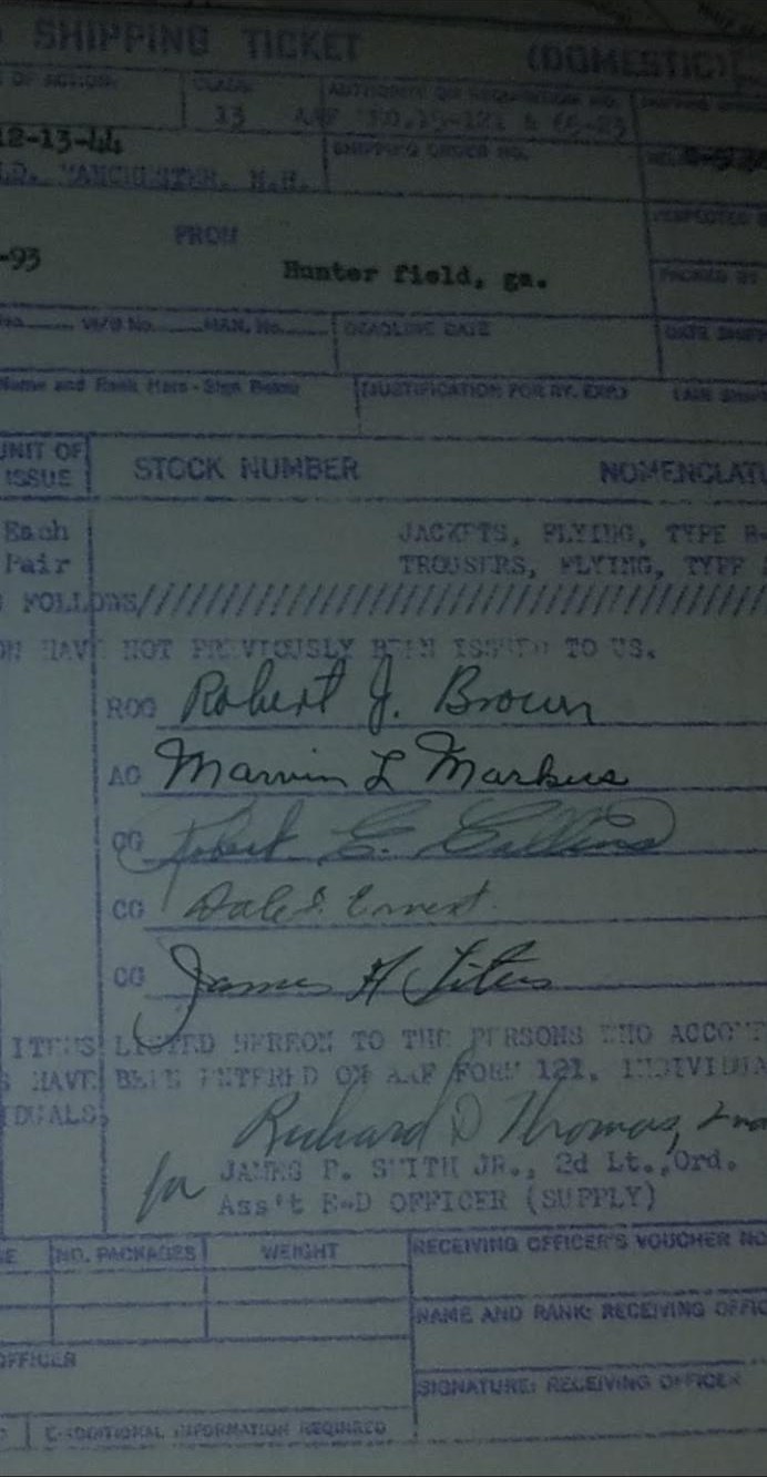 Close-up of five wartime signatures on a shipping ticket: Robert J. Brown, Marvin L. Markus, Robert E. Collins, Dale S. Ernest, and James A. Titus